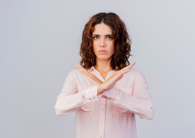 Confident young caucasian woman crosses hands gesturing no sign