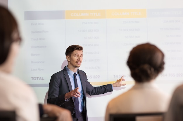 Free photo confident young man making presentation to team
