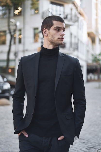 Confident young man walking on a European city street