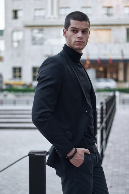 Confident young man walking on a European city street