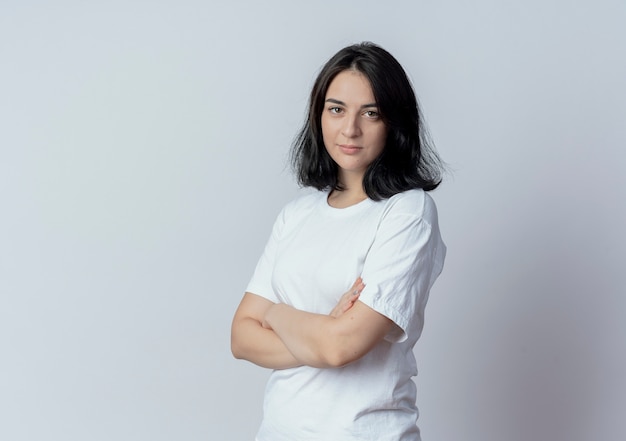 Confident young pretty caucasian girl standing with closed posture in profile view isolated on white background with copy space