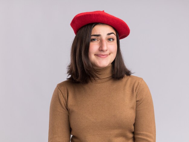 Confident young pretty caucasian girl with beret hat  isolated on white wall with copy space