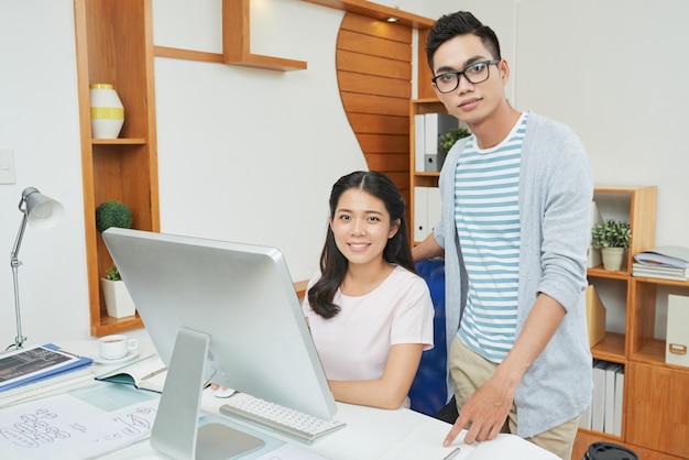 Confident young professional workers in office