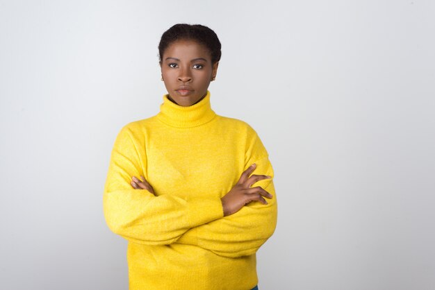 Confident young woman in yellow sweater