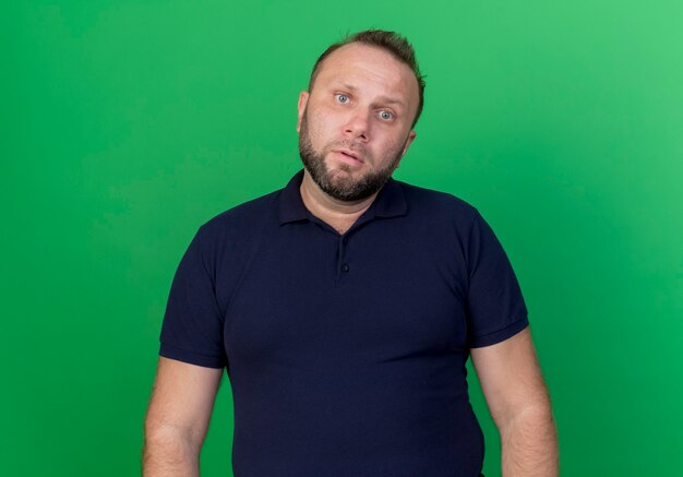 Free photo confused adult slavic man looking isolated