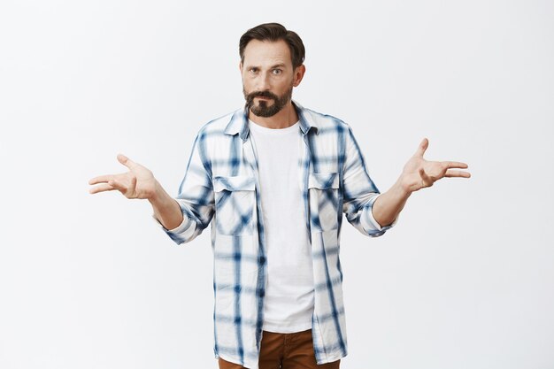 Confused bearded mature man posing