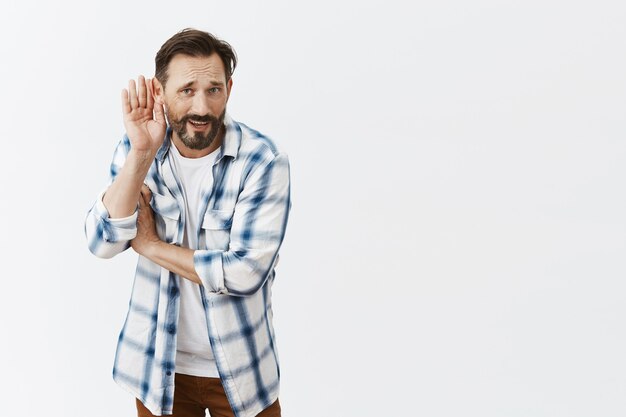 Confused bearded mature man posing