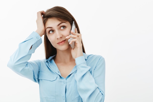 Confused brunette businesswoman posing in the studio