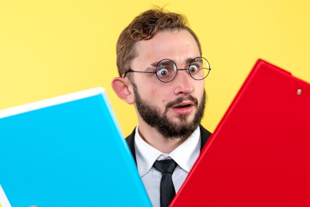 Confused business person with glasses looking the information in two documents