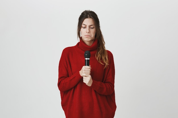 Confused girl looking puzzled at microphone