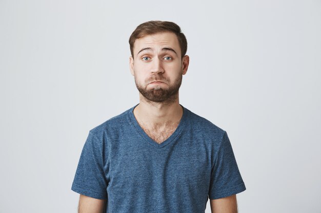 confused handsome bearded man pouting