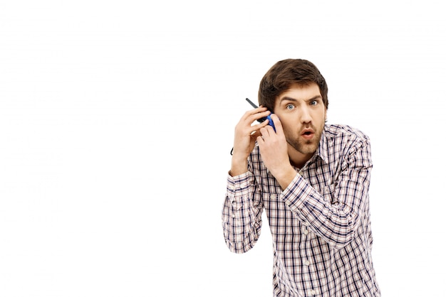 Confused man hold walkie-talkie near ear