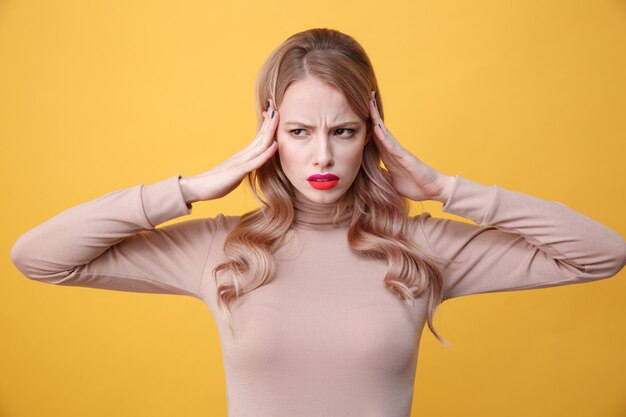 Confused sad young blonde lady with bright makeup lips