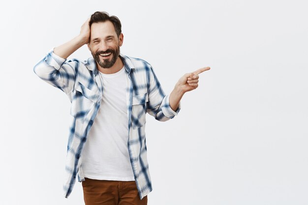 Confused and shocked bearded mature man posing
