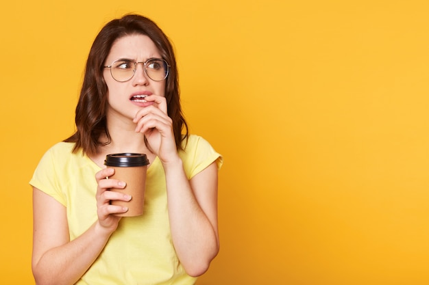 Confused thoughtful young lady looks aside