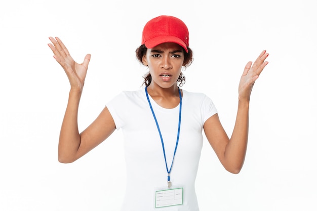 Confused young african lady wearing cap.