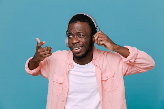Confused young africanamerican guy isolated on blue background