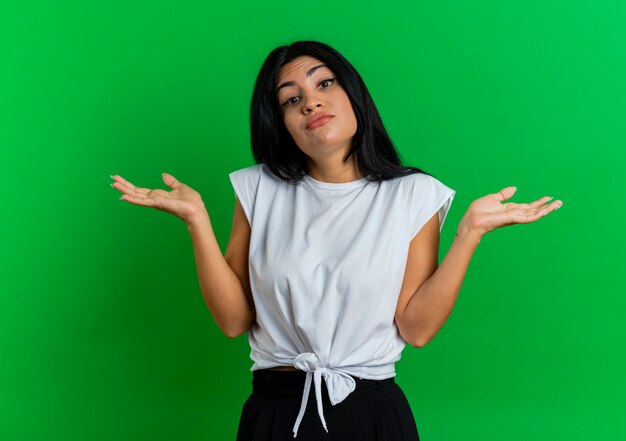 Confused young caucasian girl keeps hands open looking  