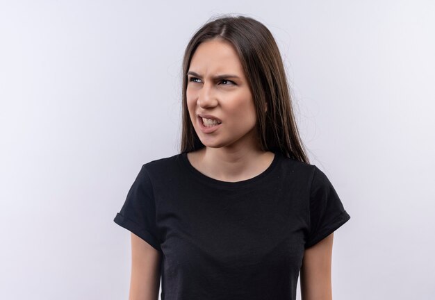 Confused young caucasian girl wearing black t-shirt on isolated white wall