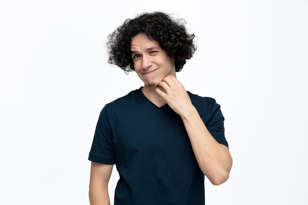 Confused young handsome man looking at camera touching chin isolated on white background