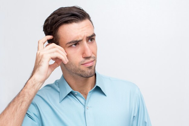 Confused Young Handsome Man Scratching Head