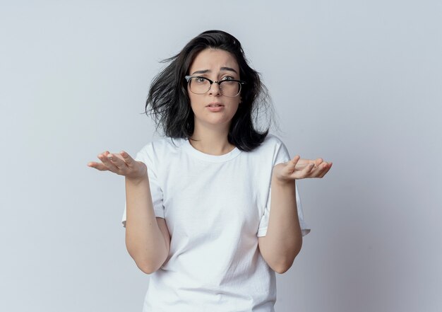 Confused young pretty caucasian girl wearing glasses showing empty hands looking at camera isolated on white background with copy space
