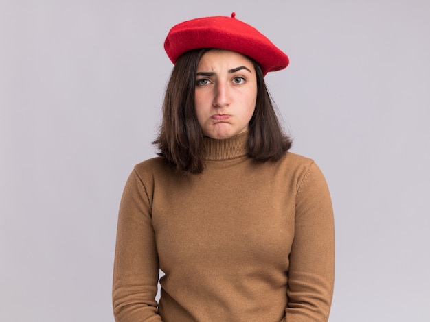 Free photo confused young pretty caucasian girl with beret hat looking at camera