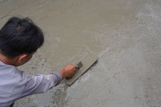 Construction technicians are mixing cement, stone, sand for construction.