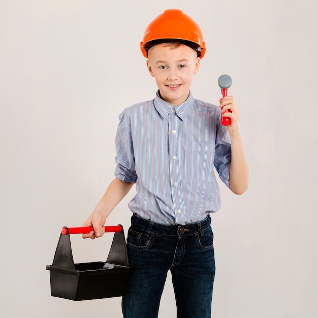 Free photo construction worker holding tool kit