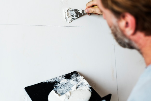 Free photo construction worker painting the wall