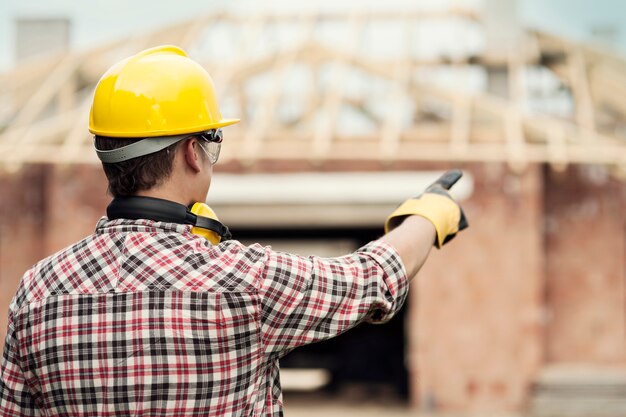 Free photo construction worker pointing at something