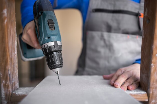 Construction worker using drill