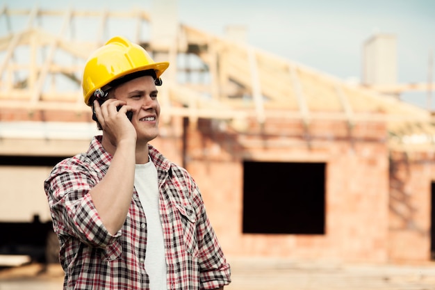 Construction worker with mobile phone