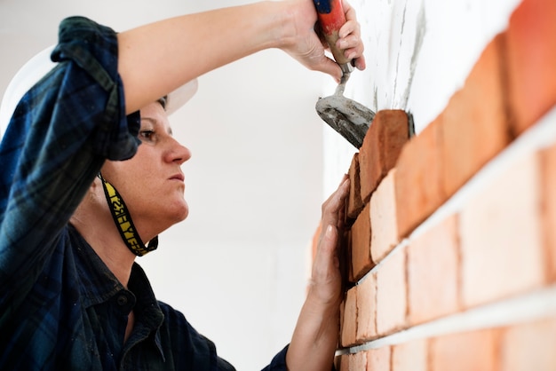 Constructor construction repair plastering on the wall