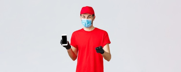 Contactless delivery payment and online shopping during covid selfquarantine smiling courier in red ...