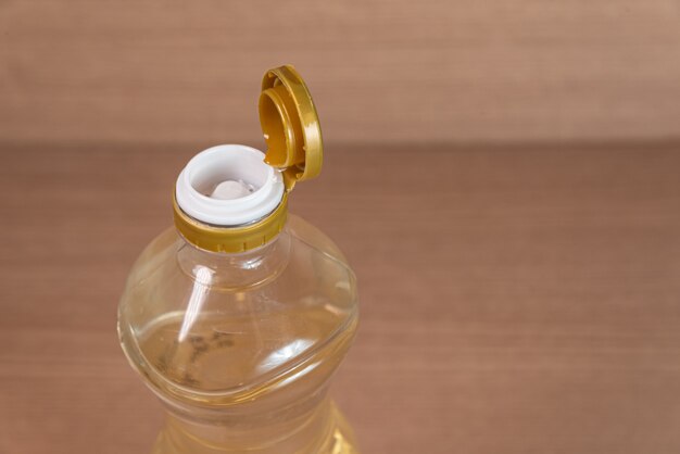 Container of vinegar on the wooden background