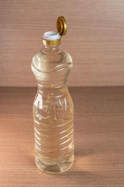 Container of vinegar on the wooden background