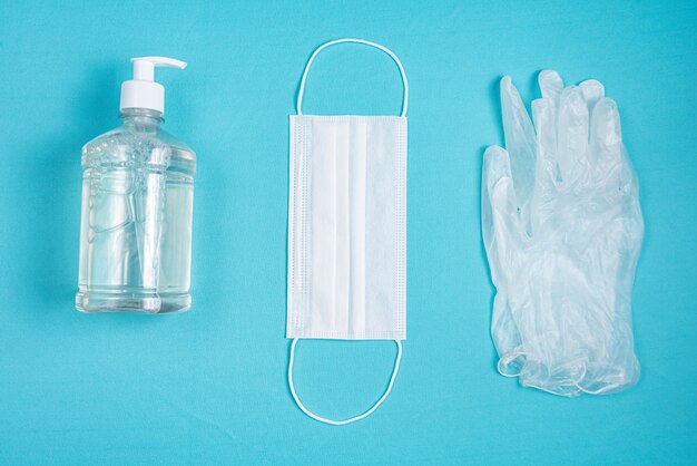 Container with alcohol gel, gloves and surgical mask 