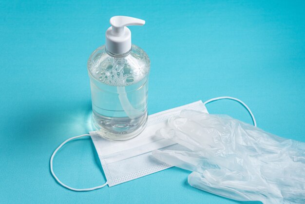 Container with alcohol gel, gloves and surgical mask 