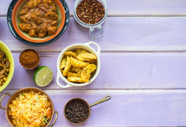 Containers with spices near lime and dishes