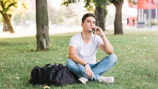 Contemplated man sitting on grass in garden