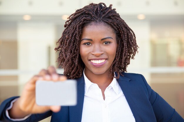 Content African American businesswoman holding blank card