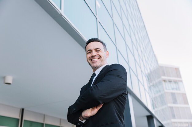 Content businessman with arms crossed