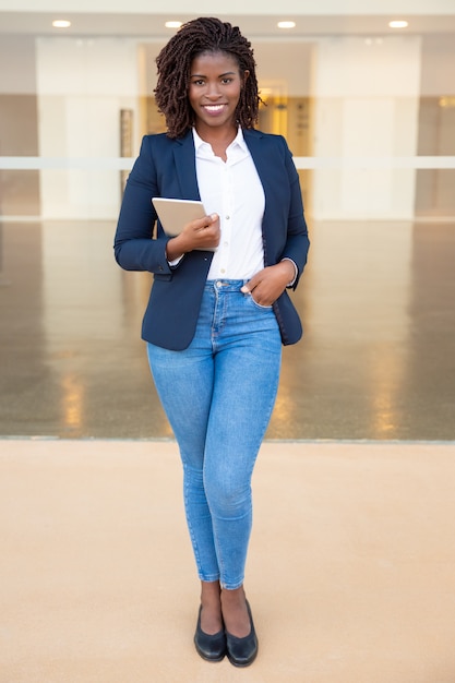 Content businesswoman holding tablet pc