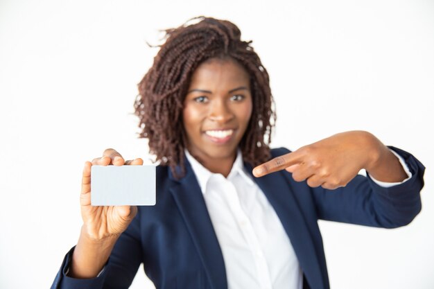 Content businesswoman pointing at card