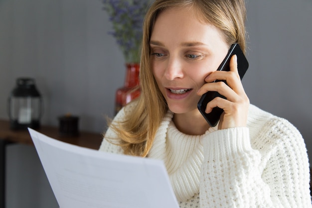 Content confident woman discussing contract on mobile phone