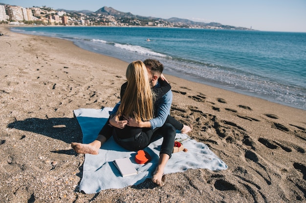 Content couple embracing on shoreline