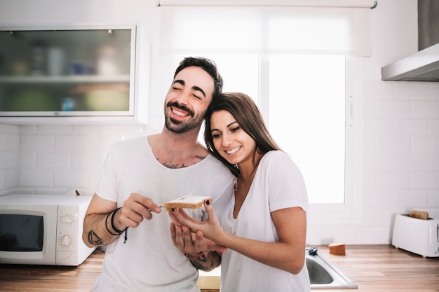 Content couple in kitchen having fun