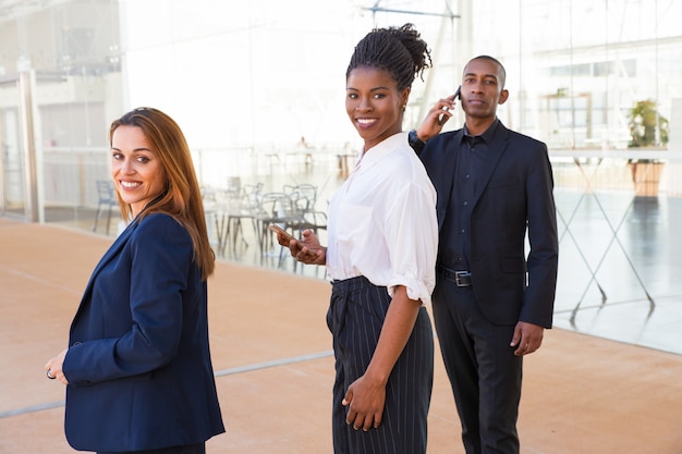 Content enterprising multi-ethnic business people in lobby