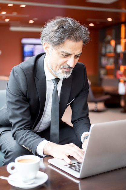 Content Entrepreneur Working on Laptop in Lobby